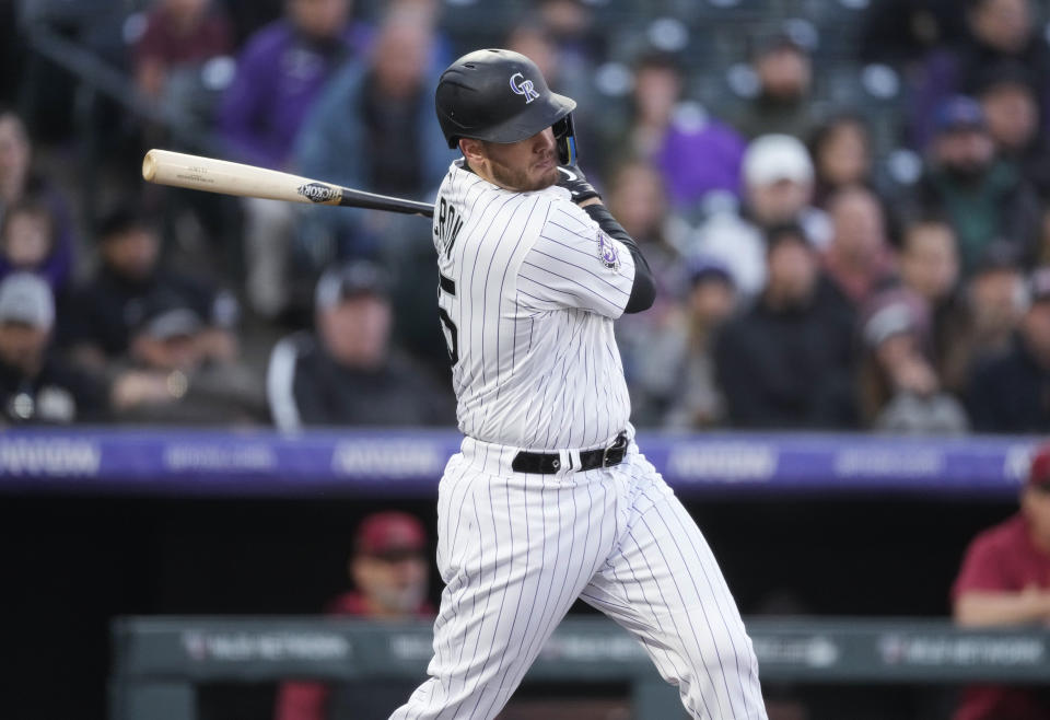 Colorado Rockies' C.J. Cron watches his RBI single off Arizona Diamondbacks starting pitcher Merrill Kelly during the third inning of a baseball game Friday, April 28, 2023, in Denver. (AP Photo/David Zalubowski)