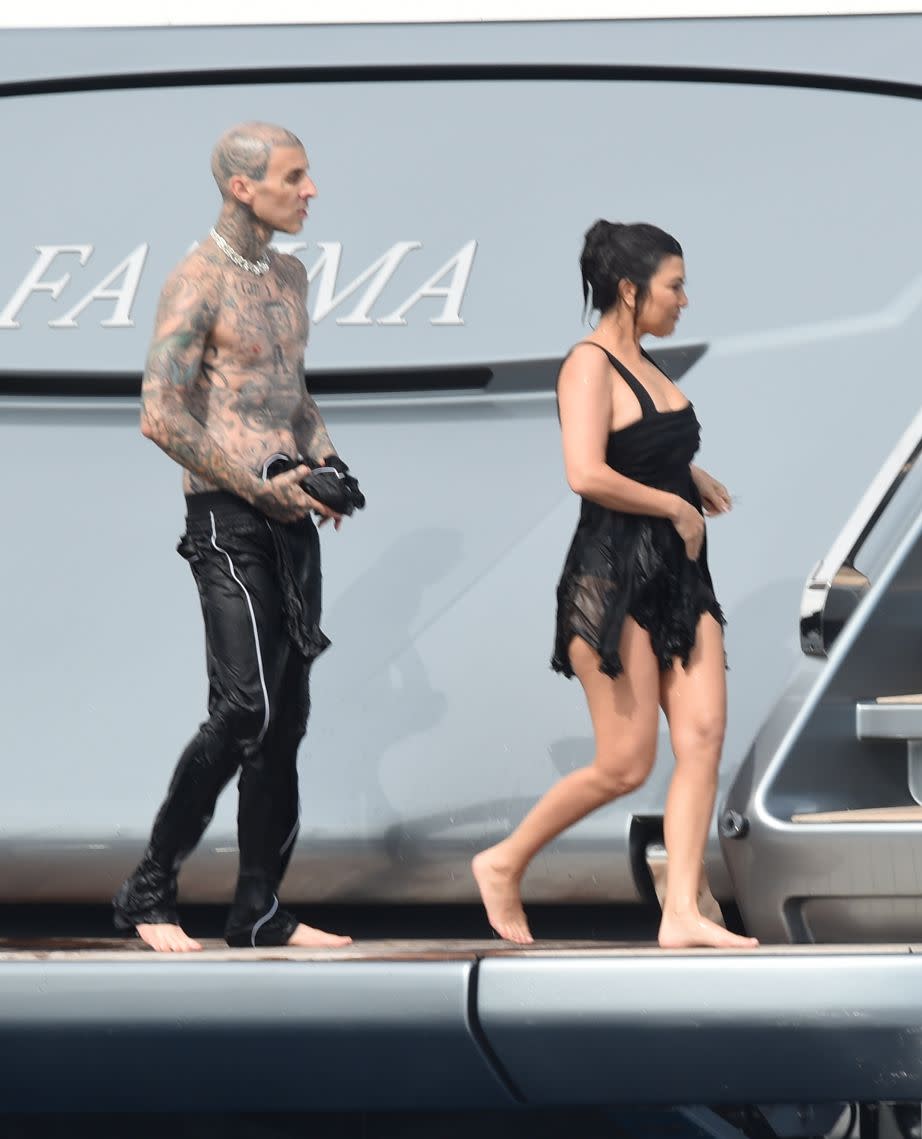 Newlyweds Kourtney Kardashian and Travis Barker relax on a yacht with family a day after their wedding in Portofino, Italy. - Credit: Elisabetta Sodi/IPA / SplashNews.com