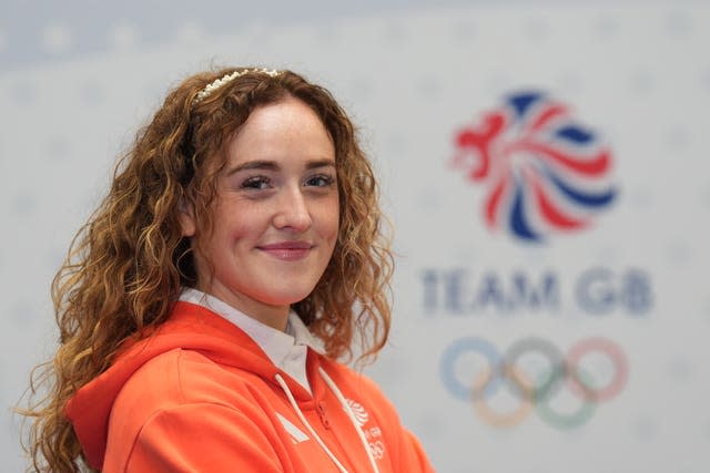 Rebecca McGowan smiling in front of a Team GB logo. 