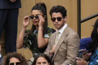 Priyanka Chopra Jonas and her husband Nick Jonas sit in the Royal Box ahead of the final of the women's singles between the Czech Republic's Marketa Vondrousova and Tunisia's Ons Jabeur on day thirteen of the Wimbledon tennis championships in London, Saturday, July 15, 2023. (AP Photo/Kirsty Wigglesworth)