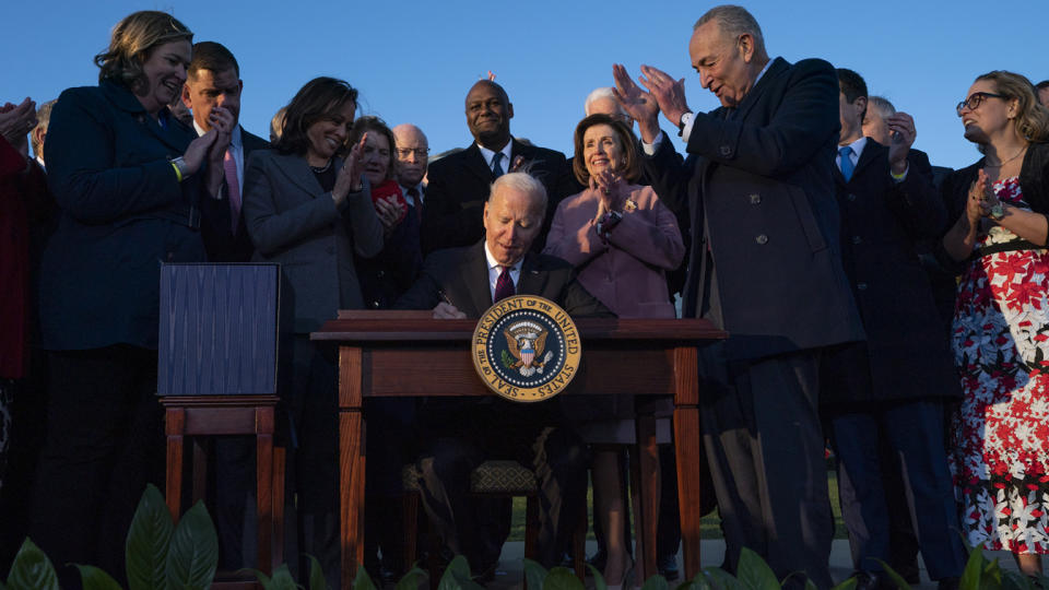 President Biden signs the Infrastructure Investment and Jobs Act at an event on the South Lawn of the White House on Monday. 