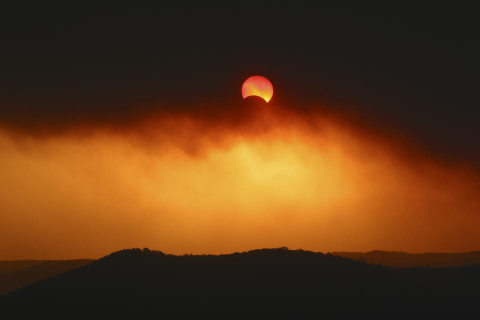 Australian solar eclipse captured in 2002 through bushfire smoke