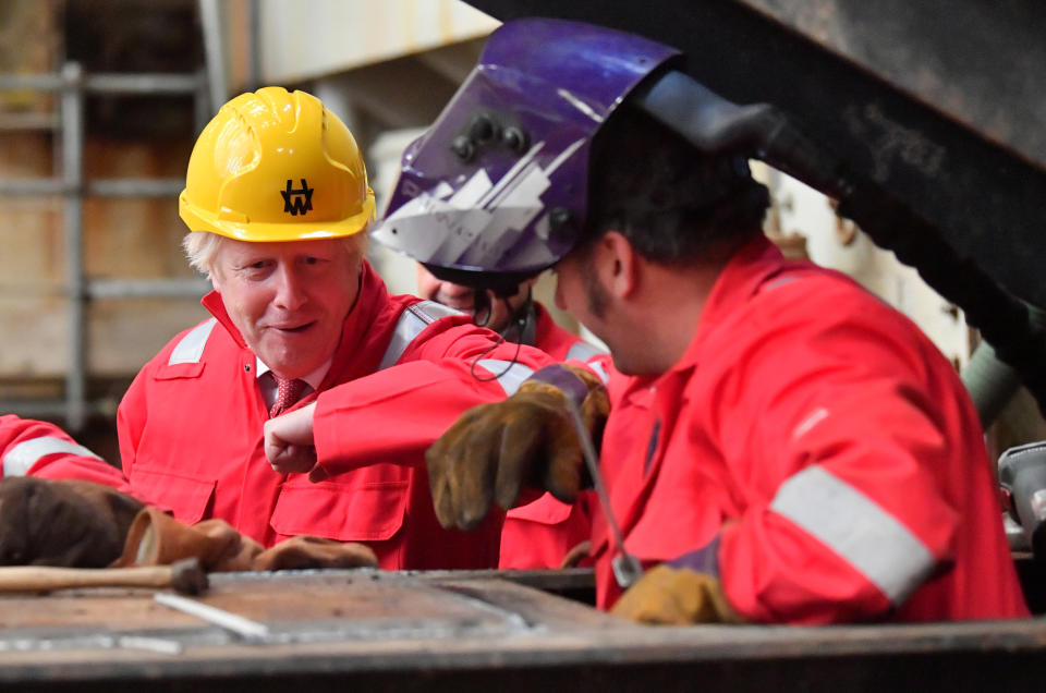 Prime Minister Boris Johnson elbow bumps a welder during his visit to Appledore Shipyard in Devon which was bought by InfraStrata, the firm which also owns Belfast's Harland & Wolff (H&W), in a �7 million deal.