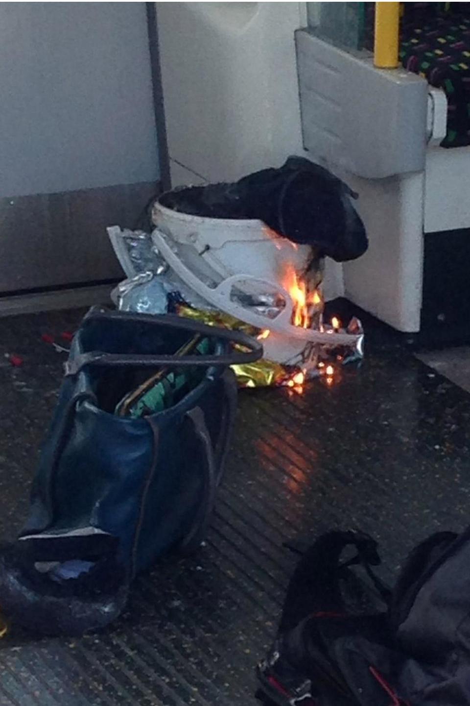 Flames coming from the apparent cause of the explosion, a bucket wrapped in a Lidl carrier bag. (@RRigs)