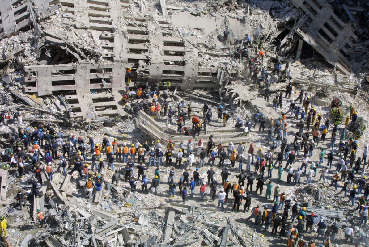 <p>Photo by Mario Tama/Getty Images</p><p>A somber scene of people.</p>