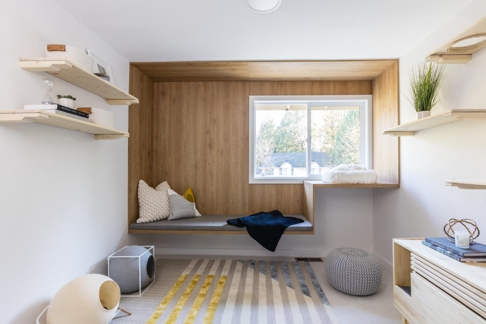 This image released by Anna Popov shows a spare room that was converted to a reading room with climbing shelves and cubbies for cats to enjoy in Redmond, Wash., designed by Anna Popov. (John Granen via AP)