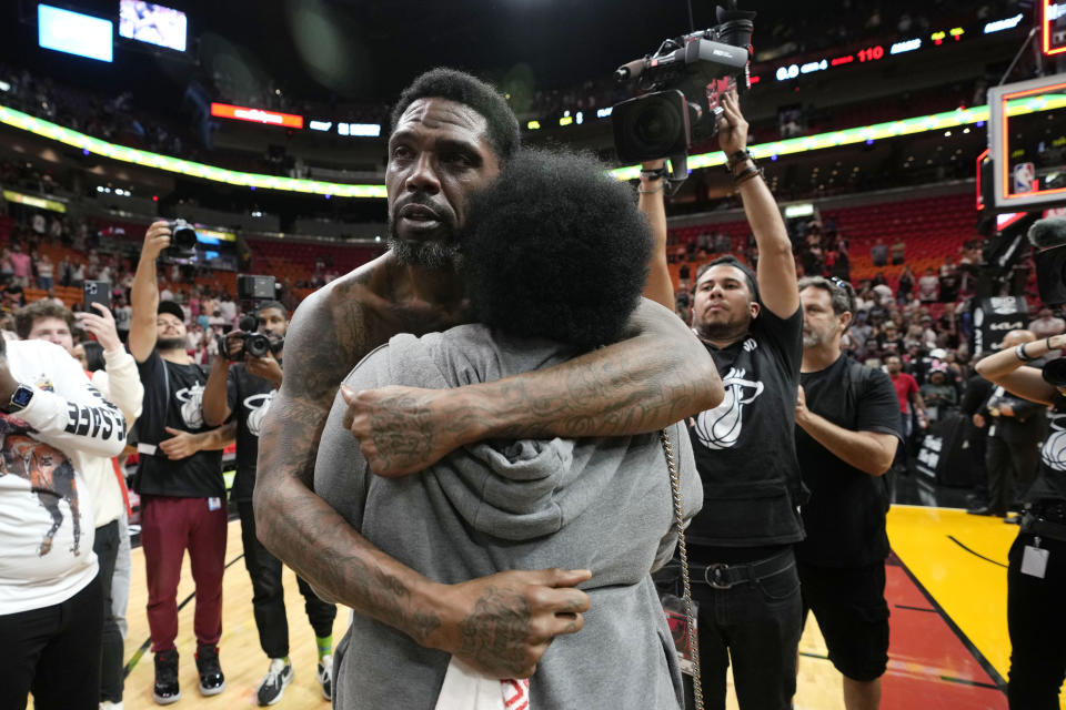 Miami Heat forward Udonis Haslem hugs Barbara Wooten after an NBA basketball game against the Orlando Magic, Sunday, April 9, 2023, in Miami. Haslem's final regular-season game with the Heat is Sunday. (AP Photo/Lynne Sladky)