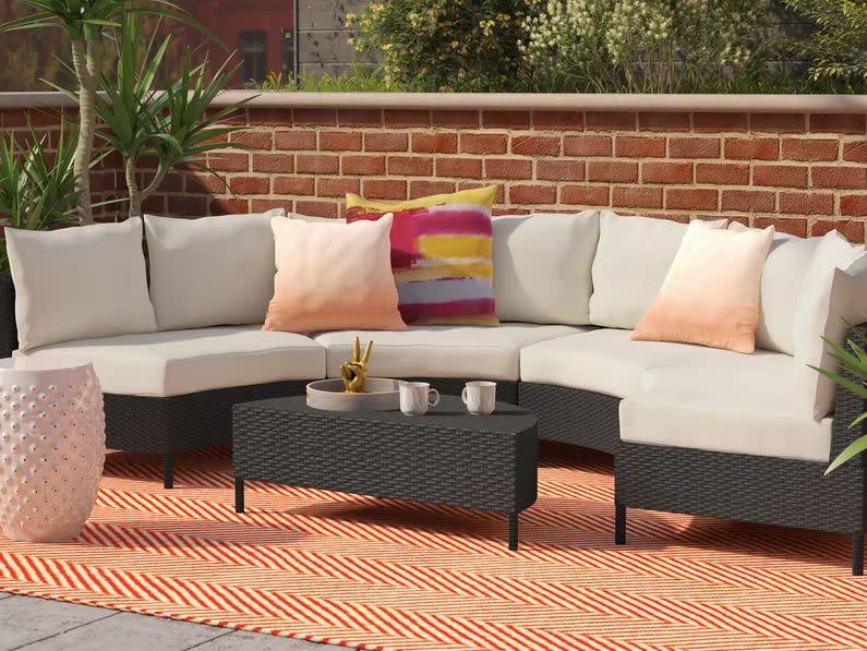 Mercury Row Dowd 5 Piece Rattan Sectional Set with Cushions. (Photo: Wayfair)