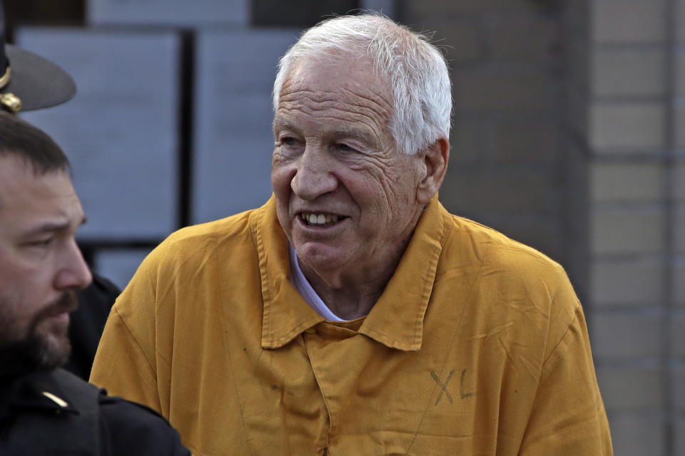 Former Penn State University assistant football coach Jerry Sandusky, center, leaves the Centre County Courthouse after attending a resentencing hearing on his 45-count child sexual abuse conviction Friday, Nov. 22, 2019. (AP Photo/Gene J. Puskar)