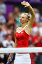 LONDON, ENGLAND - JULY 29: Maria Sharapova of Russia waves to the crowd as she celebrates match point during the Women's Singles Tennis match against Shahar Peer of Israel on Day 2 of the London 2012 Olympic Games at the All England Lawn Tennis and Croquet Club in Wimbledon on July 29, 2012 in London, England. (Photo by Ezra Shaw/Getty Images)