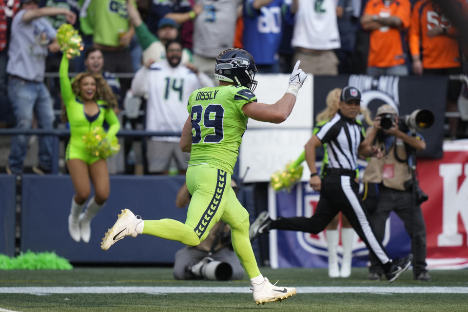 Seattle Seahawks tight end Will Dissly runs for a touchdown after catching a pass against the Denver Broncos during the first half of an NFL football game, Monday, Sept. 12, 2022, in Seattle. (AP Photo/Stephen Brashear)