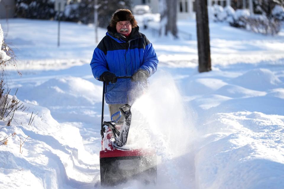 A man clears snow off a sidewalk on Thursday in Minneapolis (Copyright 2022 The Associated Press. All rights reserved)