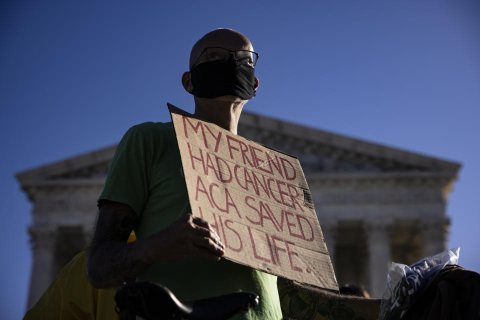 A supporter of the Affordable Care Act (ACA) stands in front of the Supreme Court of the United States as the Court begins hearing arguments from California v. Texas about the legality of the ACA on November 10, 2020 in Washington, DC. (Samuel Corum/Getty Images)
