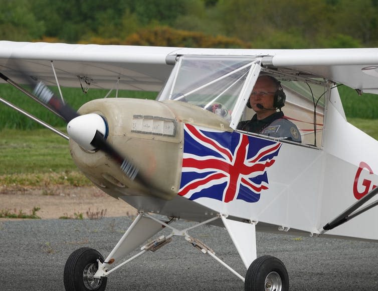 The author sits in a small electric plane