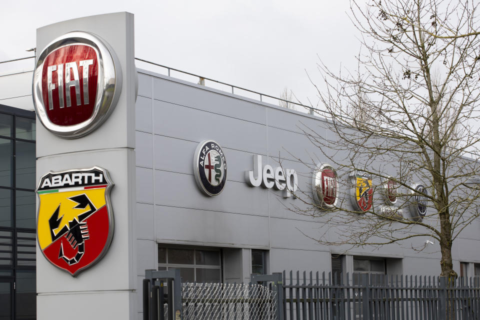 Logos of car companies are seen on the facade of the building housing Stellantis headquarters in Lijnden, near Amsterdam, Netherlands, Monday, Jan. 18, 2021. Stellantis, the car company combining PSA Peugeot and Fiat Chrysler, was launched Monday on the Milan and Paris stock exchanges, giving life to the fourth-largest car company in the world. (AP Photo/Peter Dejong)