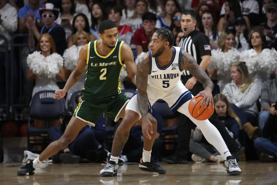 Villanova's Justin Moore, right, tries to get past Le Moyne's Kaiyem Cleary during the first half of an NCAA college basketball game, Friday, Nov. 10, 2023, in Villanova, Pa. (AP Photo/Matt Slocum)