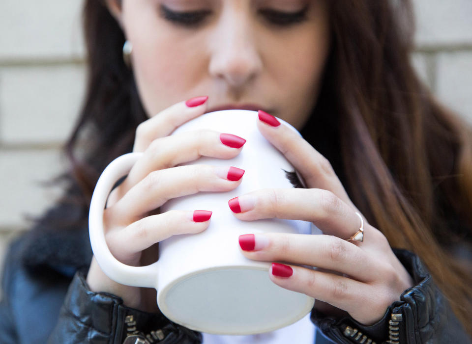 Yahoo Lifestyle associate video producer Kat Vasquez shows off color-blocked ruby red nails. (Photo: Casey Hollister for Yahoo Lifestyle)