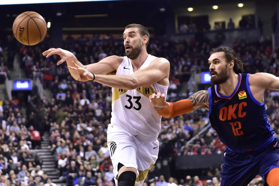 Toronto Raptors center Marc Gasol (33) passes the ball as Oklahoma City Thunder center Steven Adams (12) defends during first-half NBA basketball game action in Toronto, Friday, March 22, 2019. (Frank Gunn/The Canadian Press via AP)