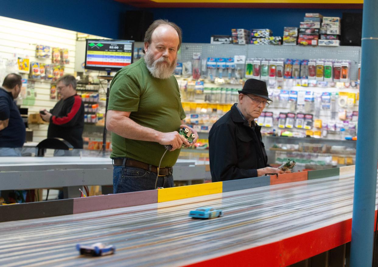 Ralph Middaugh of Massillon and Bill Phelps of Canton race slot cars at Marks Model World and Slot Car in Massillon.