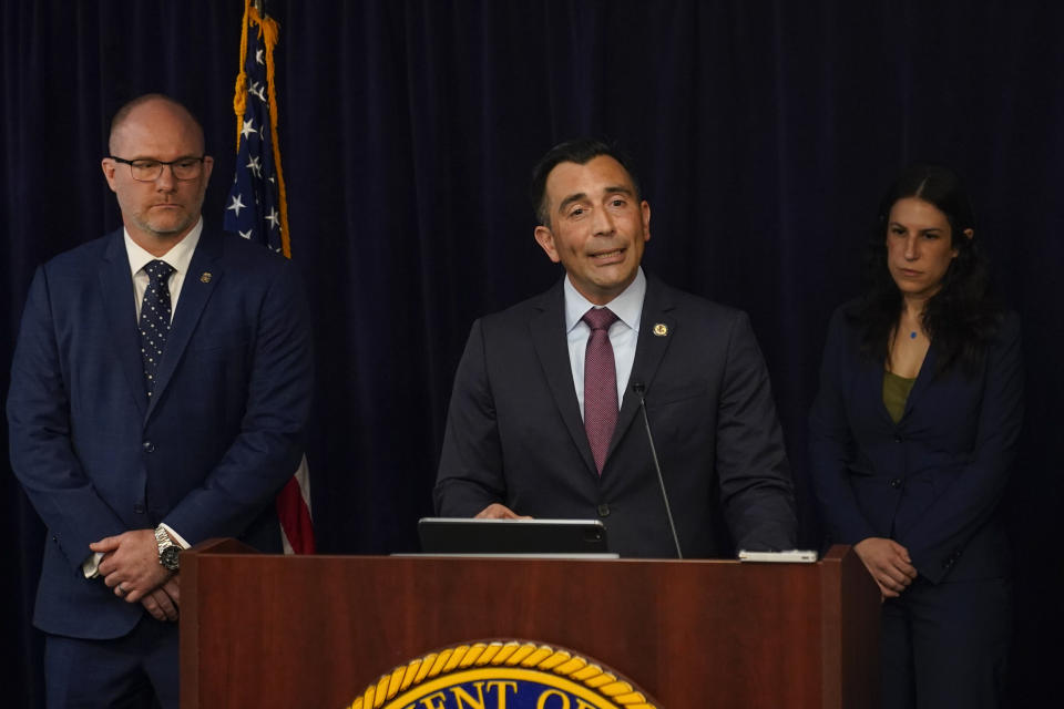 U.S. Attorney Martin Estrada, center, announces charges against the former longtime interpreter for Los Angeles Dodgers star Shohei Ohtani during a news conference Thursday, April 11, 2024, in Los Angeles. Ippei Mizuhara is being charged with federal bank fraud for crimes involving gambling debts and theft of millions of dollars from the Japanese sensation, federal authorities said. (AP Photo/Ryan Sun)