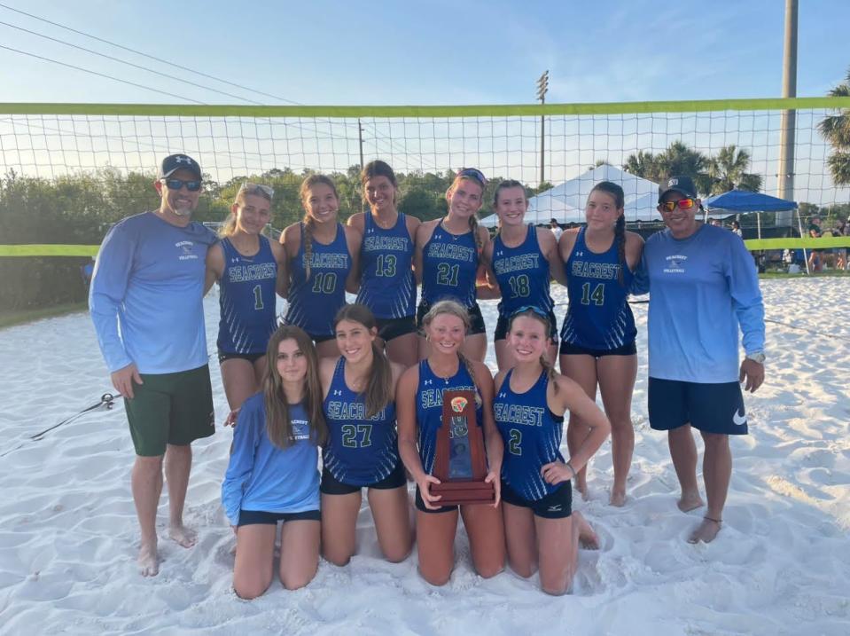 The Seacrest Country Day beach volleyball team poses for a picture following their 3-2 win over Estero to capture the Class 1A-District 24 championship on the campus of the Community School of Naples.