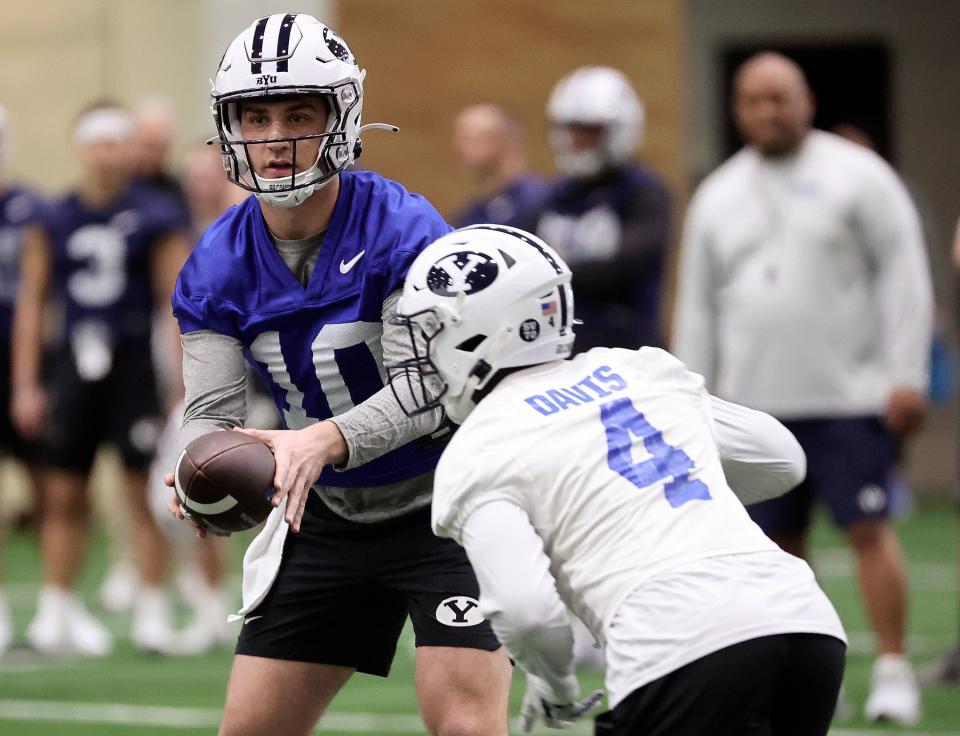 BYU quarterback Kedon Slovis hands the ball off to Miles Davis during opening day of BYU spring football camp at the BYU Indoor Practice Facility in Provo, on Monday, March 6, 2023.