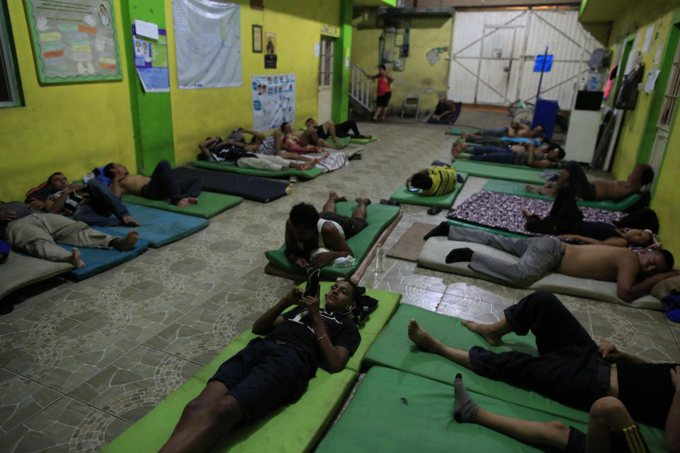 Male migrants bed down for the night on mattresses on the ground in the entry court of the Good Shepherd shelter in Tapachula, Mexico, Tuesday, June 18, 2019. Mexico's ramped-up effort to curb the flow of Central American migrants to the United States so far hasn't eased the burden on the dozens of independent humanitarian shelters like Good Shepherd that are scattered along migration routes through the country. (AP Photo/Rebecca Blackwell)