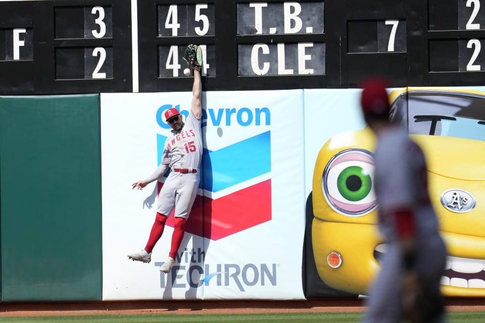 Los Angeles Angels left fielder Randal Grichuk (15) cannot catch a triple hit by Oakland Athletics' Aledmys Diaz during the sixth inning of a baseball game in Oakland, Calif., Sunday, Sept. 3, 2023. (AP Photo/Jeff Chiu)