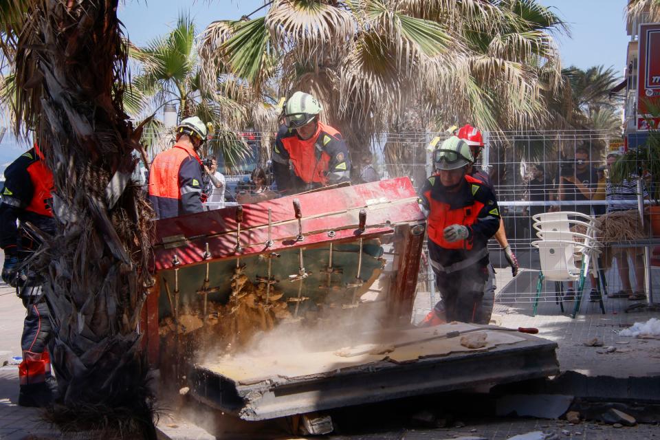 Spanish firefighters search the site after a restaurant collapsed last night (EPA)