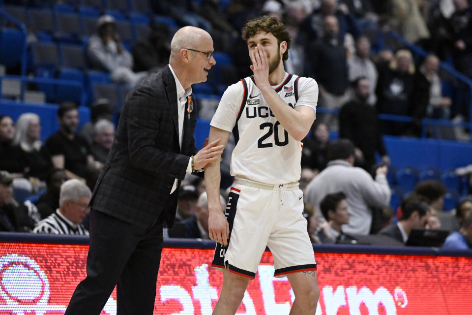 UConn head coach Dan Hurley speaks with his son UConn guard Andrew Hurley (20) after Hurley makes a basket in the second half of an NCAA college basketball game against Xavier, Sunday, Jan. 28, 2024, in Hartford, Conn. (AP Photo/Jessica Hill)