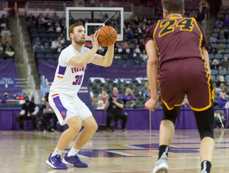 Evansville’s Noah Frederking (30) takes a three-point shot as the University of Evansville Purple Aces play the Loyola Chicago Ramblers at Ford Center in Evansville, Ind., Tuesday evening, Jan. 18, 2022. Loyola Chicago won 77-48.