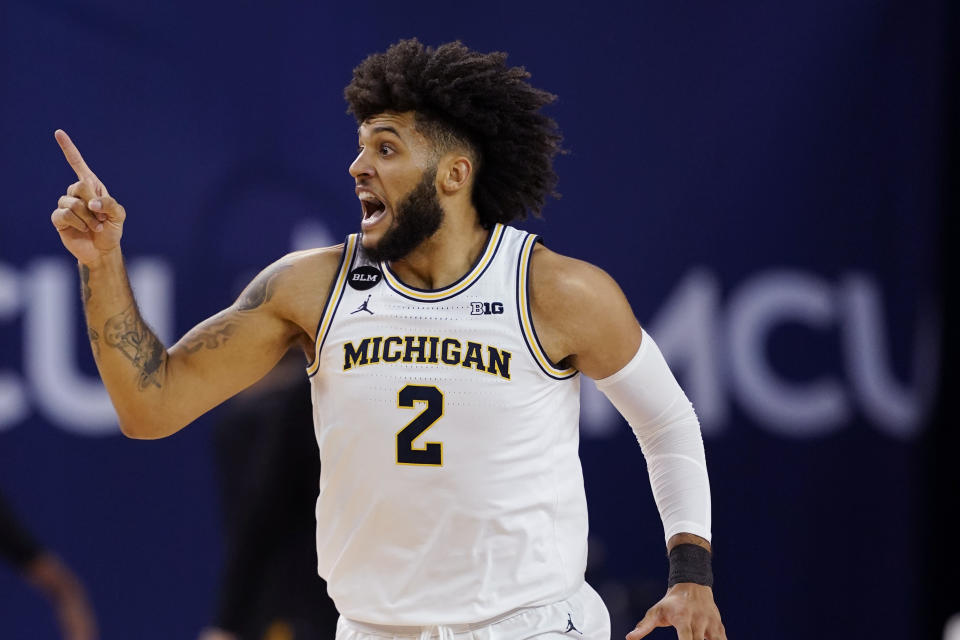 Michigan forward Isaiah Livers reacts after hitting a three-point basket during the first half of an NCAA college basketball game against Iowa, Thursday, Feb. 25, 2021, in Ann Arbor, Mich. (AP Photo/Carlos Osorio)