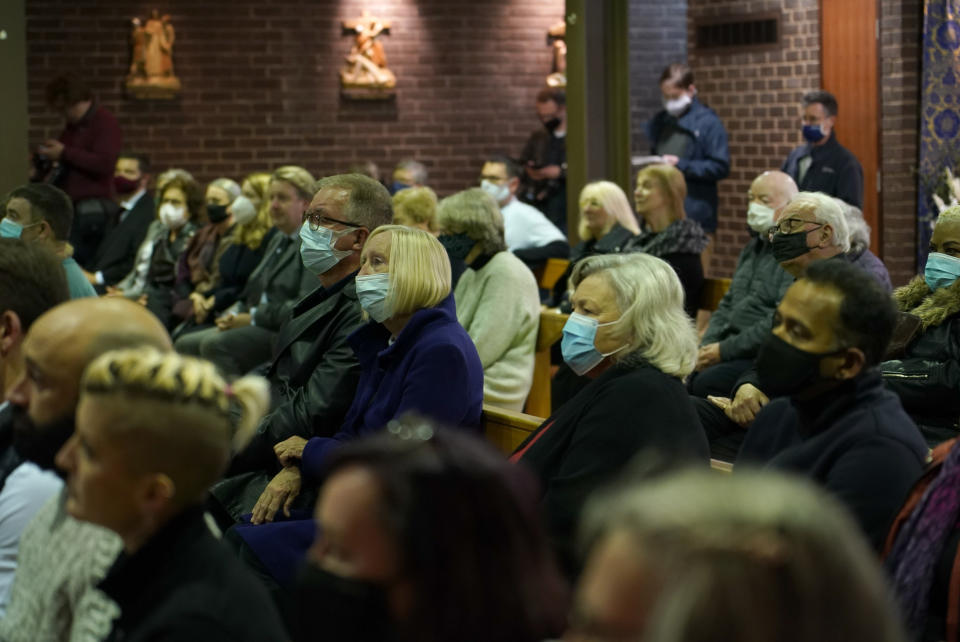 People attend a vigil to murdered British Conservative lawmaker David Amess in St Peters Catholic Church in Leigh-on-Sea, Essex, England, Friday, Oct. 15, 2021. Amess died after being stabbed earlier Friday during a meeting with constituents at another nearby church in eastern England. Police gave no immediate details on the motive for the killing of 69-year-old Conservative lawmaker Amess and did not identify the suspect, who was being held on suspicion of murder. (AP Photo/Alberto Pezzali)
