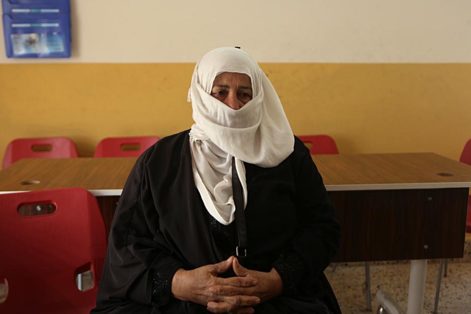 In this Feb. 26, 2019 photo, a mother of a missing man listens to an attorney at a legal clinic supported by the Norwegian Refugee Council, in west Mosul, Iraq. Thousands of Iraqi families face crushing social and legal discrimination -- all because of the choices their male relatives made under the Islamic State group’s rule. Registrars refuse to register their births, marriages or divorces; schools won’t let their children enroll. (AP Photo/Khalid Mohammed)