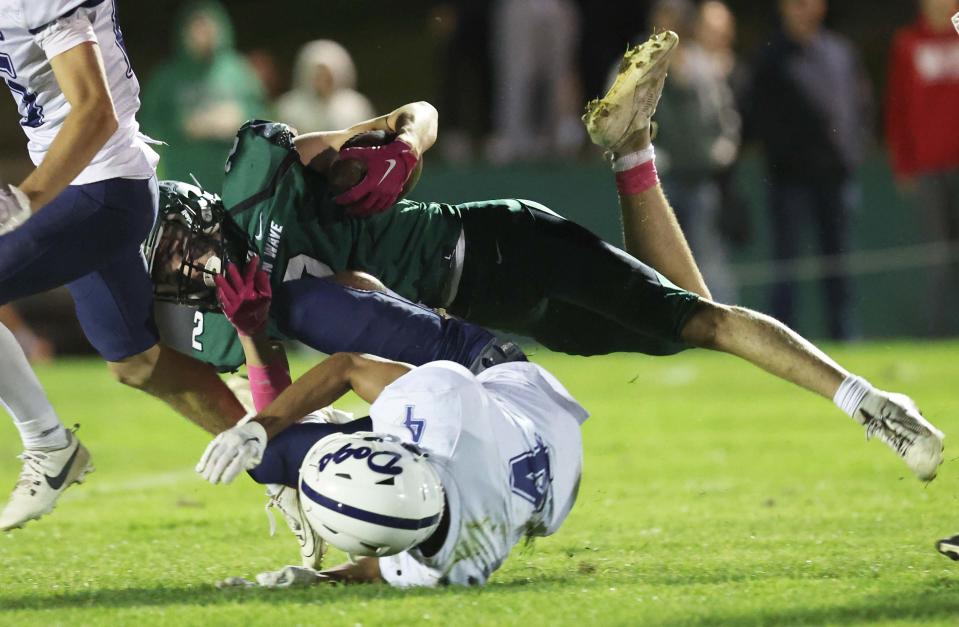 Abington running back Ryan Solimini is tackled by Rockland's Terran Williams during a game on Friday, Oct, 13, 2023.