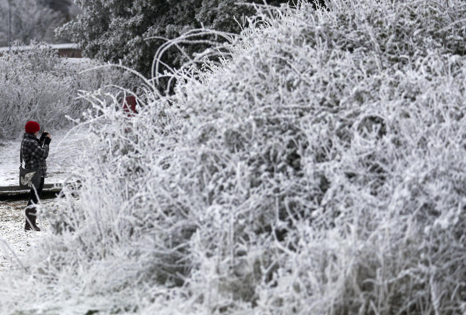 A walker photographs the snow and frost in Marchwood near Southampton. (Photo by Steve Parsons/PA Images via Getty Images)