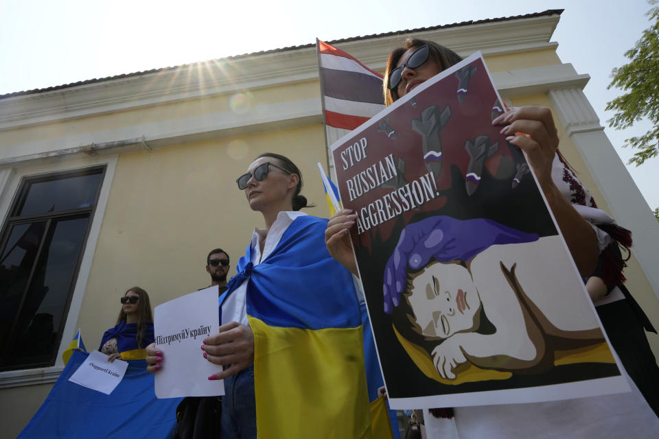 Ukrainian people living in Thailand stage a rally to mark the one-year anniversary of Russia's invasion of Ukraine, in Bangkok, Thailand, Friday, Feb. 24, 2023. (AP Photo/Sakchai Lalit)