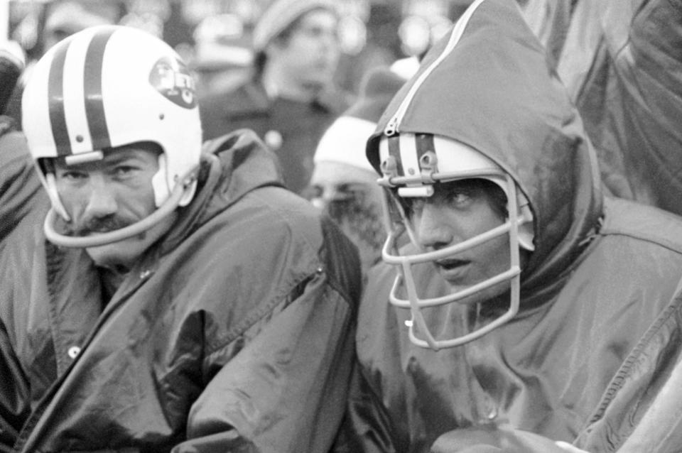 FILE - New York Jets' Don Maynard, left, and Joe Namath watch from the bench dureing a football game against the Cleveland Browns Jets quarterback Joe Namath, resting an ankle injury, nestles against the cold as he sits out game against Cleveland Browns at Shea Stadium in New York on Dec. 17, 1972. In some shots wide receiver Don Maynard (single face bar) sits next to him. Don Maynard, a Hall of Fame receiver who made his biggest impact catching passes from Joe Namath in the wide-open AFL, has died. He was 86. The Pro Football Hall of Fame confirmed Maynard's death on Monday, Jan. 10, 2022, through his family.(AP Photo/Harry Harris, File)