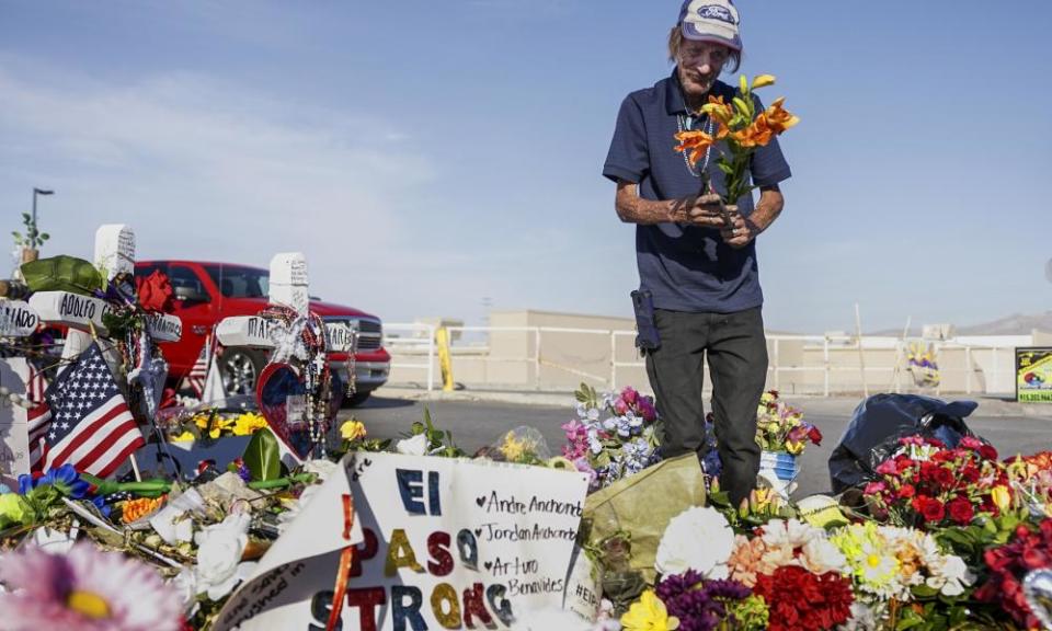 Antonio Basco, whose wife Margie Reckard was one of 22 killed at a local Walmart, lays flowers in her honor at a memorial on 16 August 2019 in El Paso, Texas.