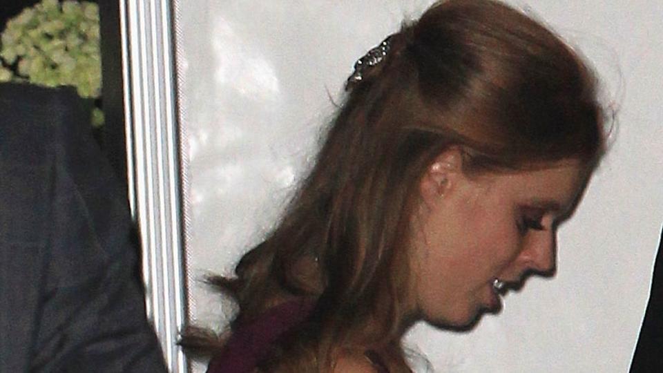 Princess Beatrice in trainers and a red dress at William and Kate's wedding afterparty