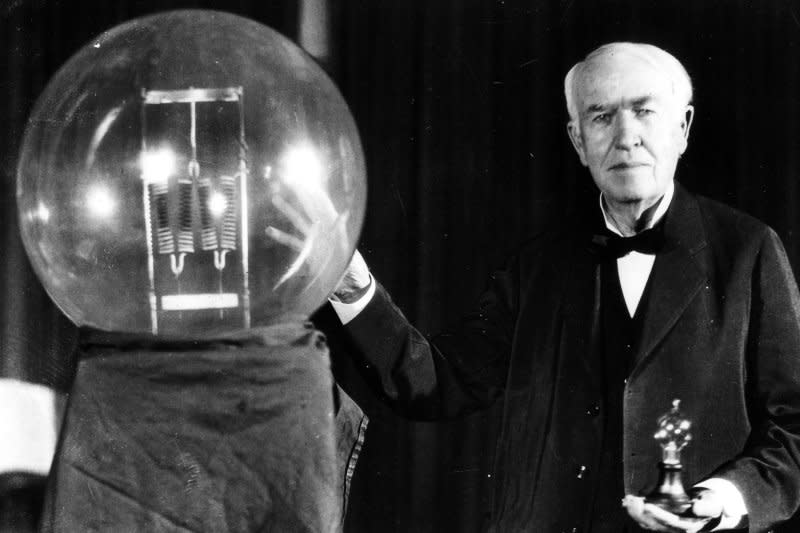 Thomas Edison holds a replica of his first lamp, which had the power of 16 candles. On October 11, 1868, Edison filed papers for his first invention: an electrical vote recorder to rapidly tabulate floor votes in the U.S. Congress. UPI File Photo