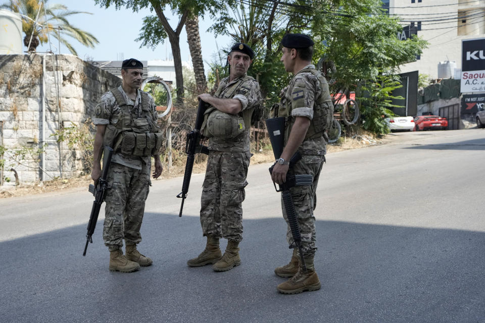 Lebanese security stand guard on a road that leads to the U.S. Embassy in Aukar, a northern suburb of Beirut, Lebanon, Wednesday, June 5, 2024. A gunman was captured by Lebanese soldiers after attempting to attack the U.S. Embassy near Beirut on Wednesday, the military said. (AP Photo/Bilal Hussein)