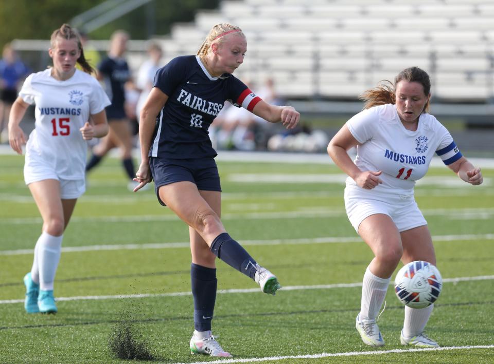 Fairless' Gracie Ashton (center) advances the ball during a game against Tuslaw in August.