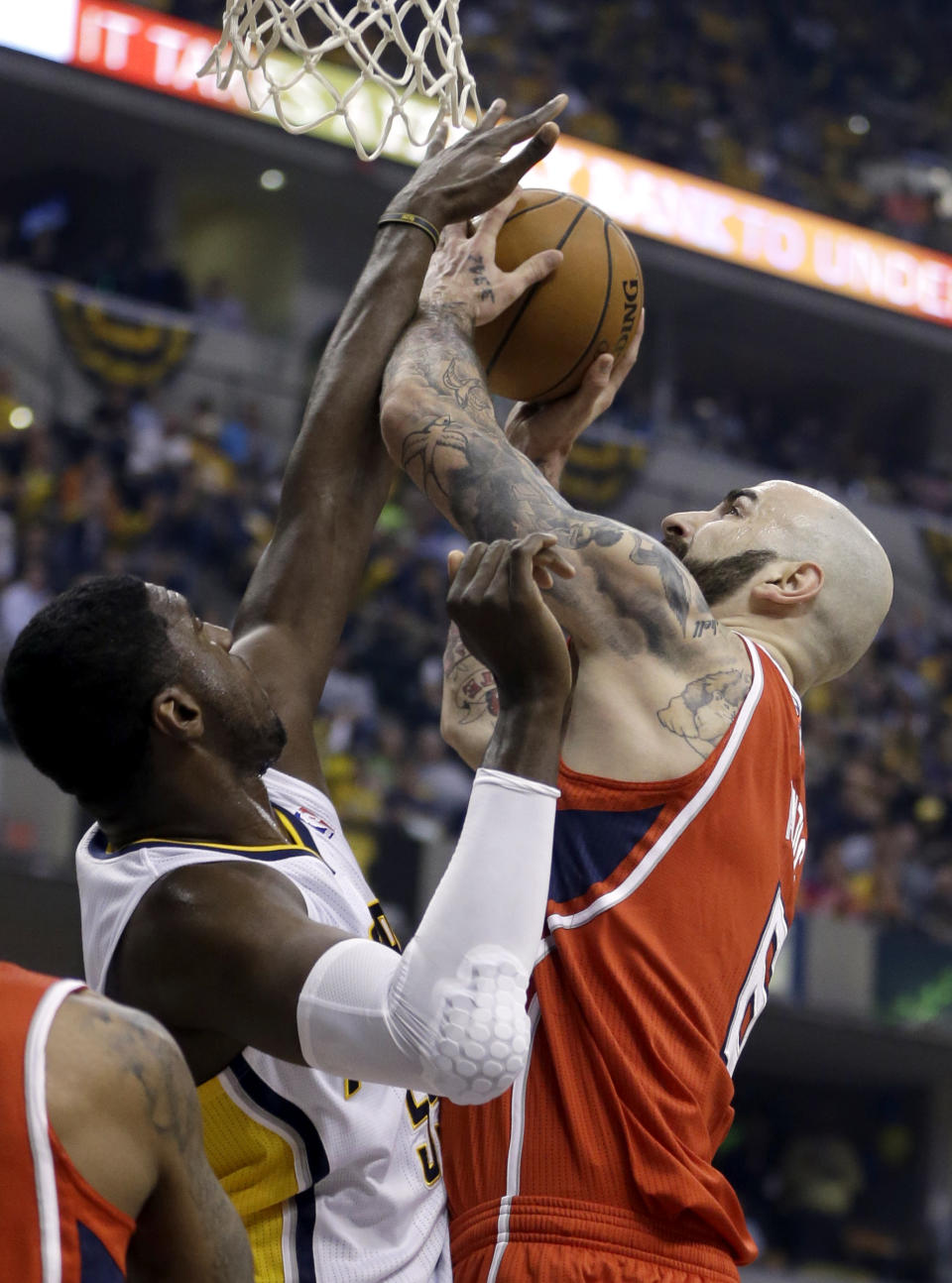 Atlanta Hawks' Pero Antic (6) has his shot blocked by Indiana Pacers' Roy Hibbert, left, during the first half in Game 5 of an opening-round NBA basketball playoff series Monday, April 28, 2014, in Indianapolis. (AP Photo/Darron Cummings)