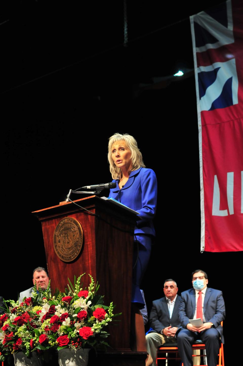 Mayor Shaunna O'Connell speaks during the City of Taunton inauguration ceremony at Taunton High School on Jan. 3, 2022 as city councilors look on. From left: John McCaul, Chris Coute and Phil Duarte.