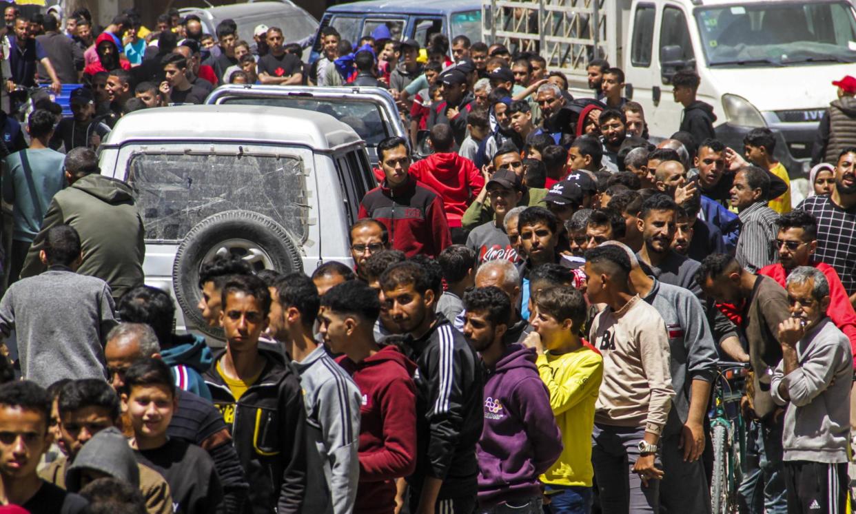 <span>Palestinians in Gaza wait in long queues to buy bread on Sunday.</span><span>Photograph: Anadolu/Getty Images</span>