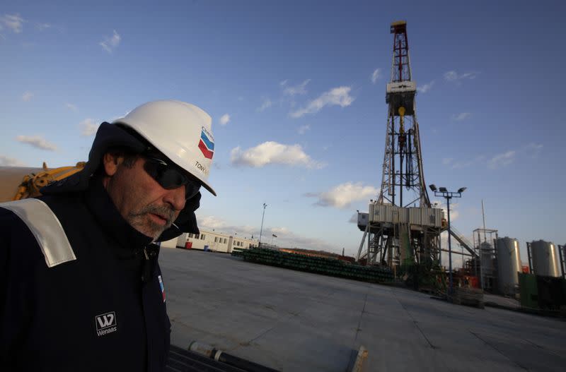 A worker stands near a drilling rig at Grabowiec 6 near the village of Lesniowice