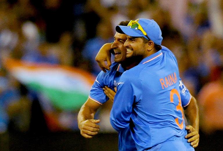 India's Mohit Sharma (L) celebrates with Suresh Raina Cricket World Cup match against South Africa in Melbourne on February 22, 2015