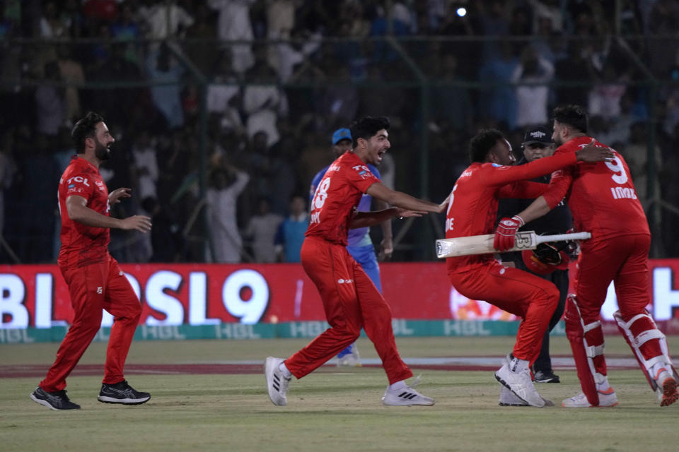 Islamabad United' Imad Wasim, right, celebrates with teammates after taking winning score during the final of Pakistan Super League T20 cricket match between Islamabad United and Multan Sultans, in Karachi, Pakistan, Monday March 18, 2024. (AP Photo/Fareed Khan)