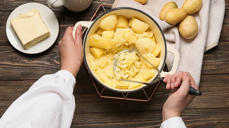 Person mashing potatoes 